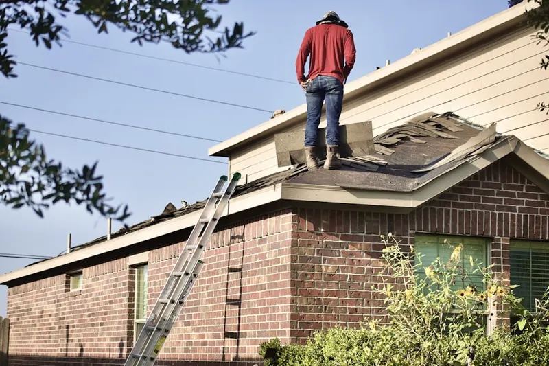 Professional roofer working on a residential roof in Bright